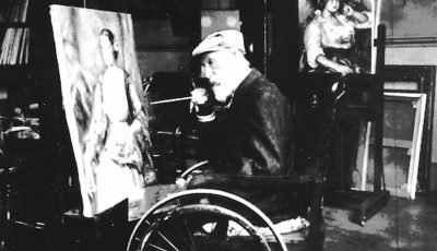Renoir in wheelchair painting in his studio